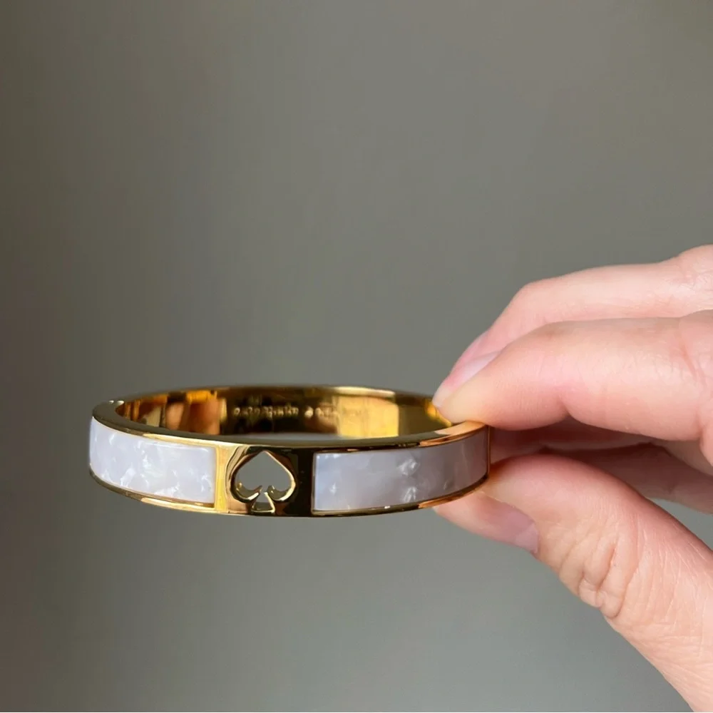 KATE SPADE PUNCH HOLE BANGLE BRACELET IN PEARLY WHITE - Picture 2 of 4